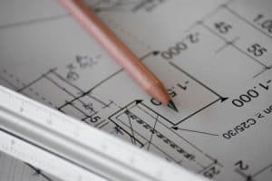 A brown pencil laying flat on a floor plan