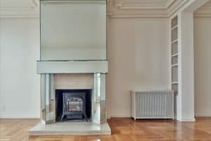 A black fireplace set against a white room with contemporary design