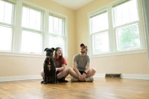 Couple and dog on empty room