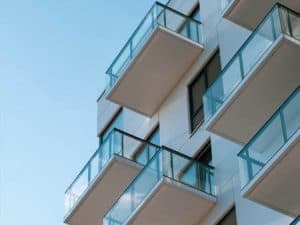 A low-angle view of balconies on a high-rise apartment building