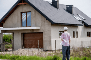 Man looking at old, pre-existing house