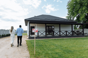 A couple walking towards a sold house for sale