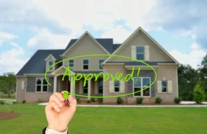 A hand writes “Approved!” in green marker over a new suburban house, symbolising successful property purchase approval in Melbourne.