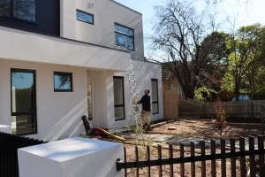 Buy Wise inspector checking exterior eaves and roofline during a pre-handover inspection