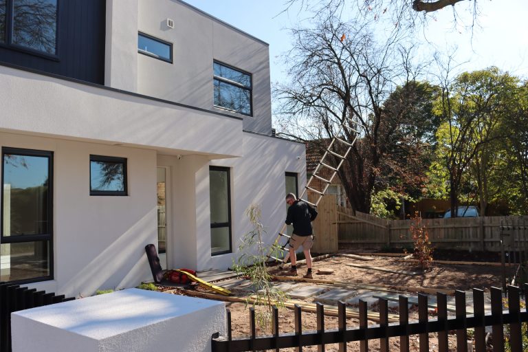 Buy Wise building inspector setting up a ladder at a Melbourne home