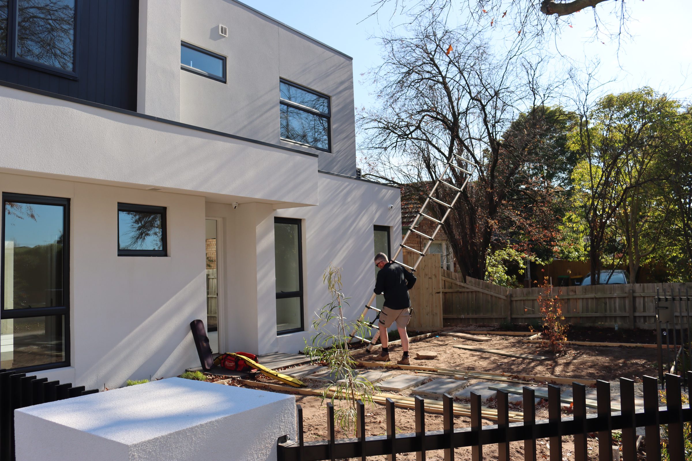 Buy Wise building inspector setting up a ladder at a Melbourne home
