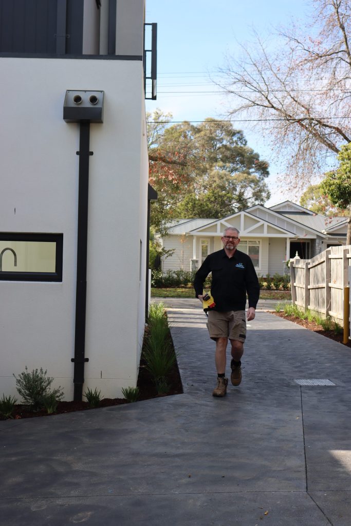 Buy Wise inspectors checking an external wall during a Melbourne building inspection